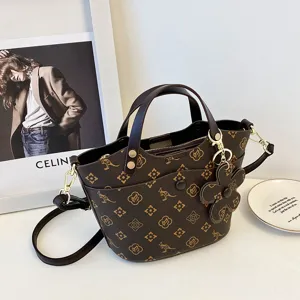 Classic retro bucket bag for women, stylish brown shoulder crossbody handbag with floral charm.