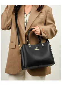 Black leather handbag for women, stylish top-handle shoulder bag with adjustable strap.