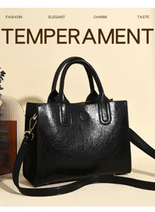 Classic black oil-wax leather tote bag with handle and shoulder strap for women daily commute.