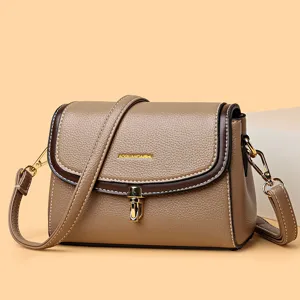 Braune Damen Umhängetasche aus Leder mit kontrastierender Paspel und goldenem Metallverschluss.