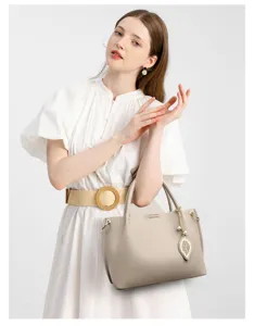 Women's soft leather handbag with leaf pendant, large capacity elegant shoulder bag.