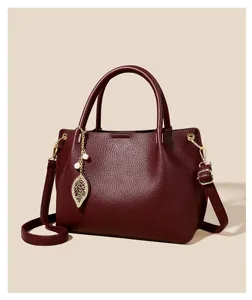 Elegant burgundy women's handbag, soft PU leather shoulder crossbody bag with gold hardware.