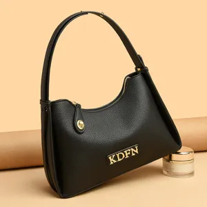Classic black leather underarm shoulder bag with chic gold hardware, stylish hobo handbag.
