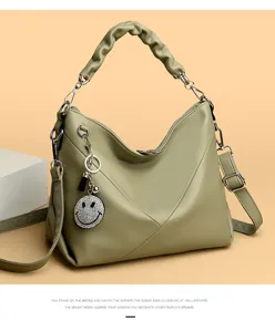 Stylish green leather hobo shoulder bag with gathered handle and sparkling rhinestone smiley charm.