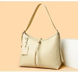 Elegant beige leather shoulder bag for women, stylish daily commuter handbag with strap.