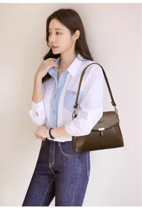 Classic brown leather shoulder bag for women, stylish crossbody purse with metallic clasp closure.