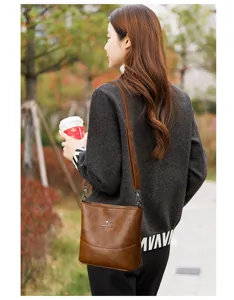Vintage brown soft leather shoulder bag for women, casual crossbody bucket bag with adjustable strap.