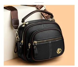 Black soft leather multi-layer shoulder crossbody bag with wide patterned strap and gold hardware.