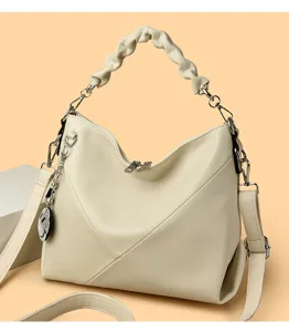Chic beige shoulder bag featuring pleated handle, metal chain, and stylish daily design.