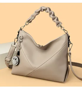 Stylish women's shoulder handbag with pleated handle and cute rhinestone smiley charm.