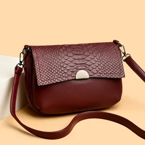 Burgundy PU leather crossbody bag for women with embossed flap and metal clasp main view