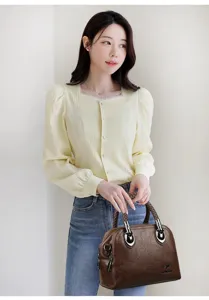 Detailed view of retro brown women handbag, multi-layer large capacity design with woven handle.