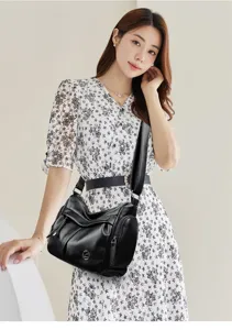 Details of women's retro leather shoulder bag, chic commuting handbag with wide strap.