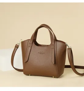 Stylish brown leather tote bag with shoulder strap, perfect for daily commuting and retro style.