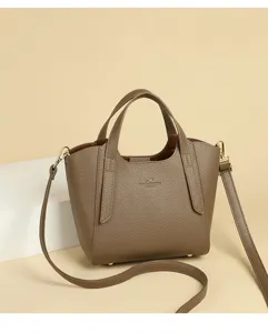 Detailed view of brown leather handbag texture, featuring classic top handle and strap design.