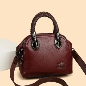 Elegant wine red leather handbag for women, vintage braided handle satchel shoulder bag.