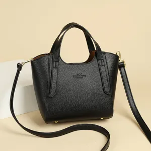 Black leather bucket bag for women, chic top-handle handbag featuring a removable shoulder strap.