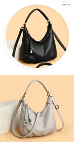 Detailed view of elegant hobo shoulder bag with stylish tassel charm and smooth leather texture.