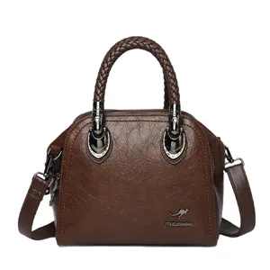 Vintage brown leather handbag with braided handle and shoulder strap for women daily use.