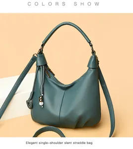 Detail view of a dark green hobo shoulder bag featuring stylish bead tassel charms and zipper.