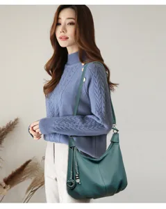 Green leather hobo shoulder bag for women, stylish crossbody handbag with tassel detail.