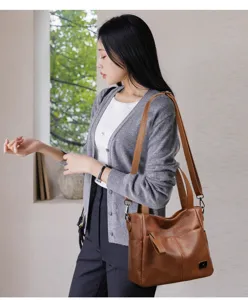 Detail shot of the brown PU leather shoulder bag showcasing soft texture, strap and pocket.