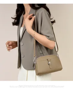 Detail view of stylish pebbled leather crossbody bag with metal buckle, casual versatile chic.