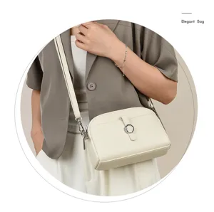 Elegant white leather crossbody shoulder bag detail, stylish small square bag for women.