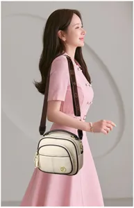Elegant soft leather apple crossbody bag with multi-layer design and stylish brown strap.