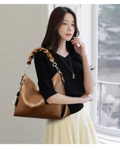 Stylish brown hobo shoulder bag for women with chic pleated handle and elegant design details.