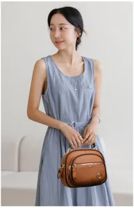Stylish women's brown leather shoulder bag with multi-layer design, soft and spacious.