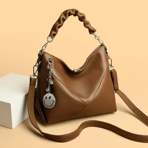 Stylish brown leather shoulder bag for women, chic gathered handle and cute rhinestone charm.