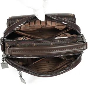 Brown monogram multi-compartment shoulder bag with top handle and secure zipper pockets.