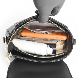 Black quilted crossbody bag interior view showing large capacity for daily essentials.