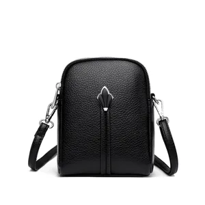 Black leather crossbody bag for women, stylish small shoulder purse with metal clasp and zip.