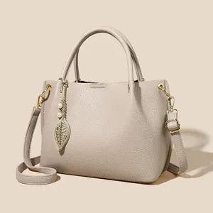 Elegant women's soft leather tote bag with leaf charm, large capacity shoulder crossbody bag.