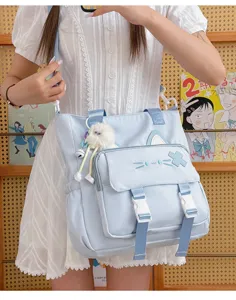 Cute cat student canvas shoulder bag, large capacity casual crossbody bag for daily use.
