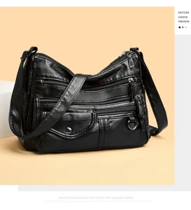 Detailed view of black PU leather multi-pocket crossbody bag with functional zippered compartments.