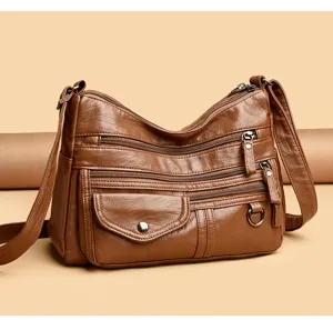 Brown PU leather multi-pocket crossbody bag detail, featuring durable zippers and metal hardware.