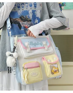 Canvas shoulder bag detail showing multi-pockets, cute bear charm, and pastel design.