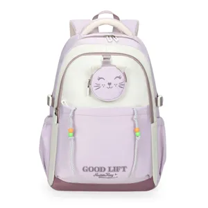 Detailed view of the cute purple and beige school backpack featuring a sweet cat design pocket.