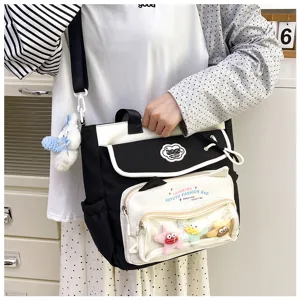 Cute black and white student canvas shoulder bag with clear front pocket for daily school use