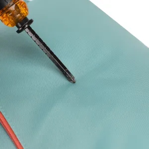Cyan backpack fabric texture detail close-up showing durable woven material and zipper.