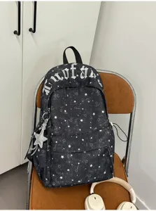 Detailed view of black canvas star backpack featuring gothic embroidery and silver pendant.