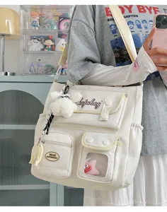 Canvas shoulder bag with multi pockets and cute bear pendant for casual daily student wear.