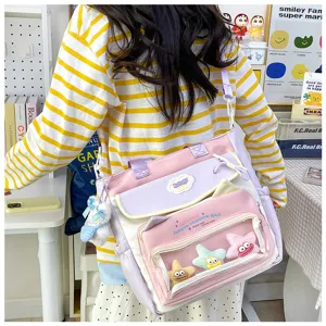 Cute style large capacity canvas shoulder bag with transparent front pocket and kawaii plush toys.