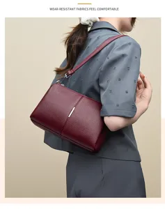 Detail shot of the burgundy leather shoulder bag showing the stylish texture and sturdy strap.