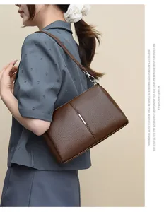 Brown leather shoulder bag detail view, elegant commuting style with premium texture.