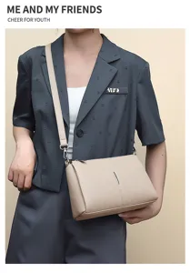 Detail view of stylish beige leather crossbody bag, minimalist design for casual daily use.