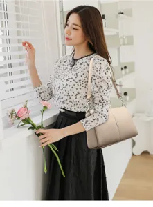 Elegant beige shoulder bag detail, stylish commuter PU leather handbag showcased in cozy interior.